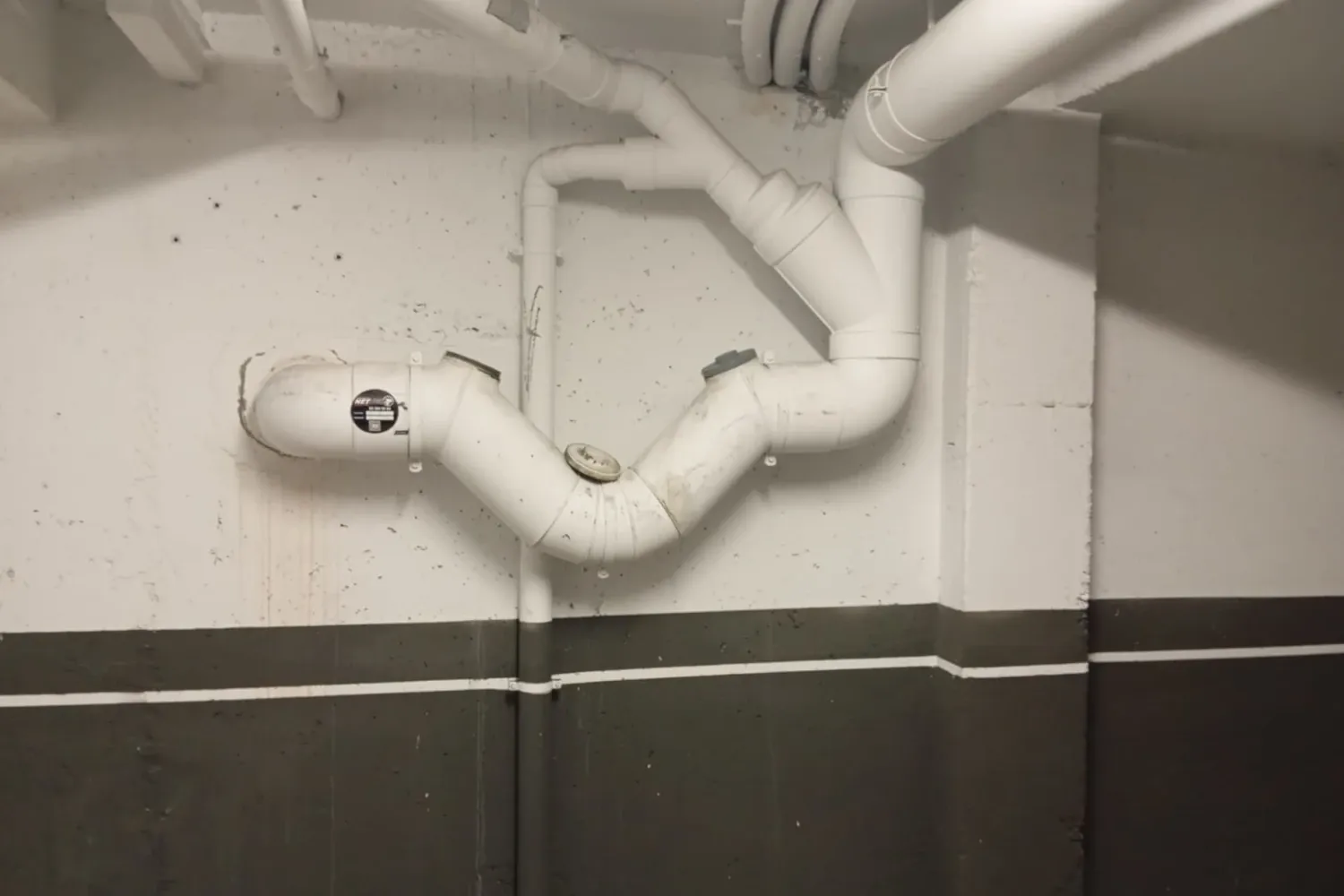 Sistema de tuberías de drenaje con solución profesional instalada en un espacio residencial. Esta imagen refleja la importancia de un mantenimiento adecuado de sistemas de desagüe para evitar obstrucciones y filtraciones. En NetJet, somos especialistas en limpieza de tuberías, desatascos, inspección con cámaras y reparaciones sin obras. Nuestra tecnología avanzada garantiza el correcto funcionamiento de cualquier sistema de saneamiento. ¡Confía en NetJet para mantener tus instalaciones libres de problemas!